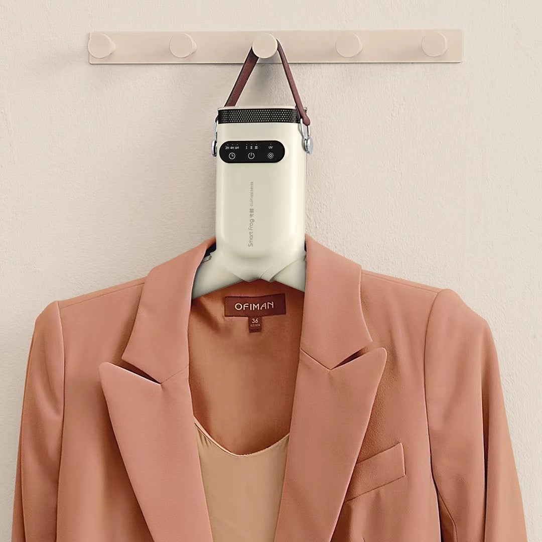 Pink blazer with a beige top on a hanger against a beige wall.
